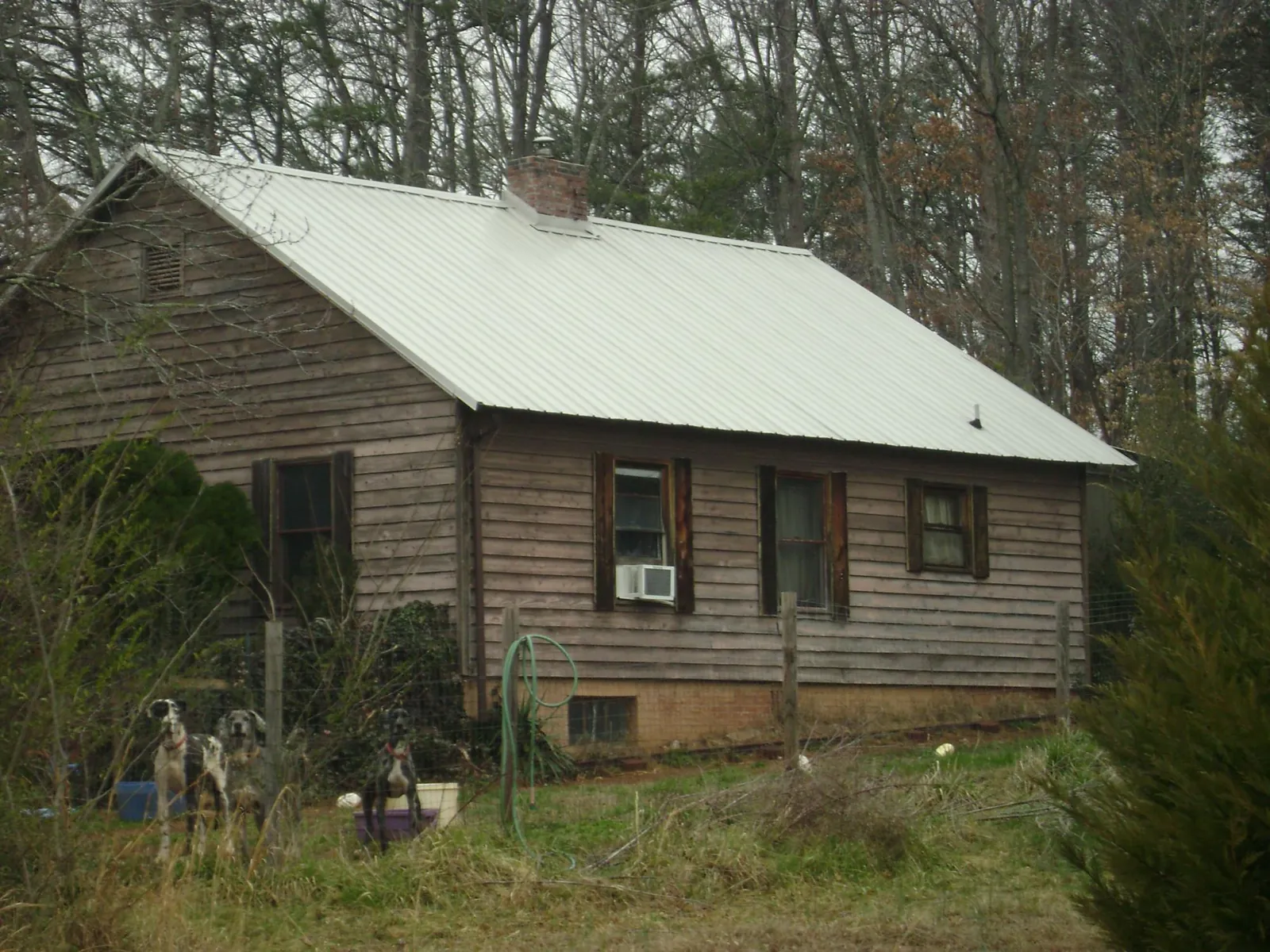 White metal roof on an old wood sided farmhouse, from a Metal Roof Installation job in South Beloit